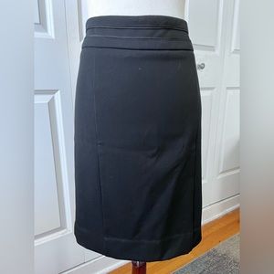 White House Black Market black skirt with waistline detail and back slit.